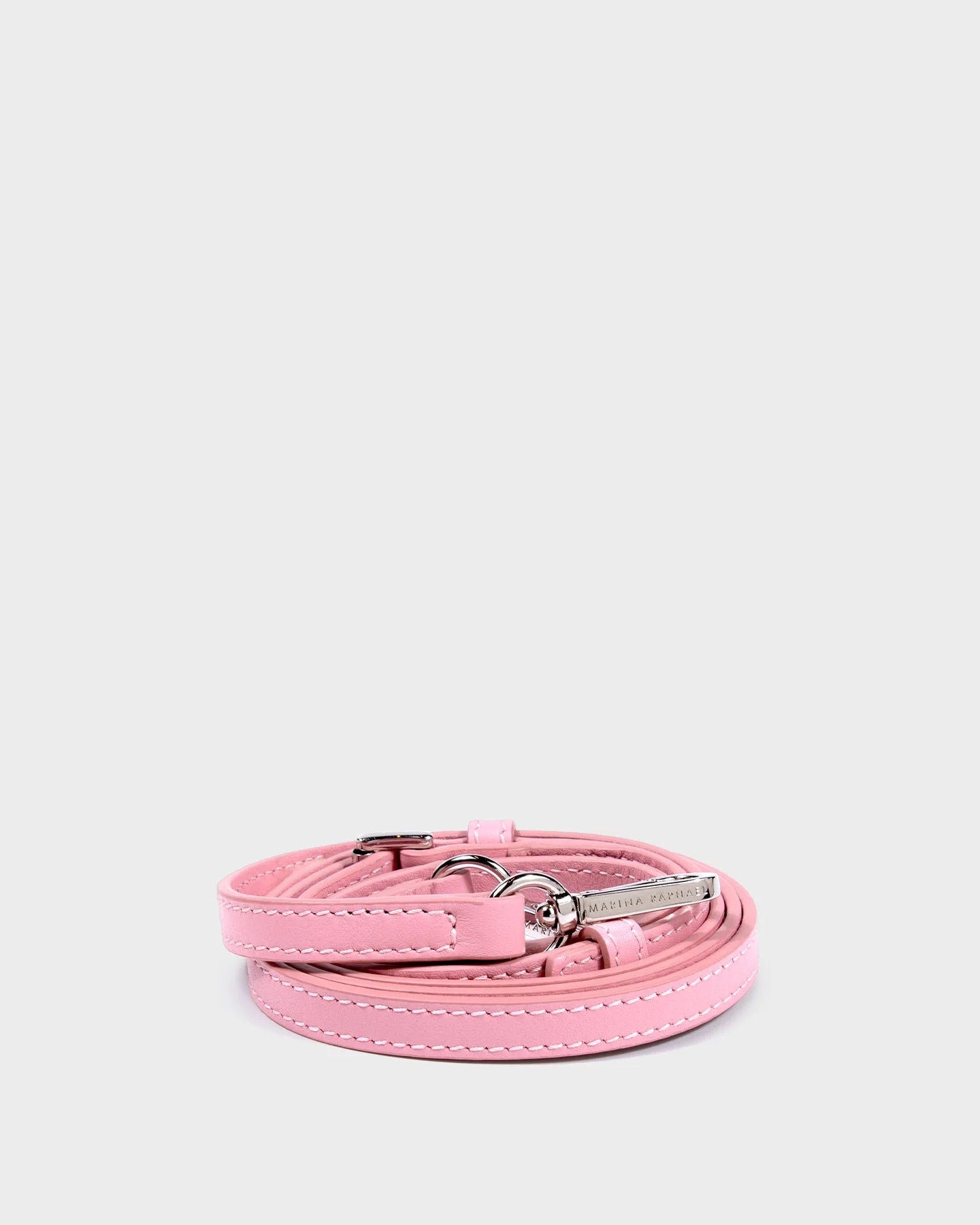 Thin, adjustable, pink, napa leather strap with silver hardware and exposed stitching