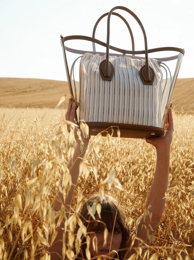 Page from the January 2022 issue of Io Donna Italy magazine featuring: the Marina Raphael Porter in Clear PVC and Striped Canvas Handbag