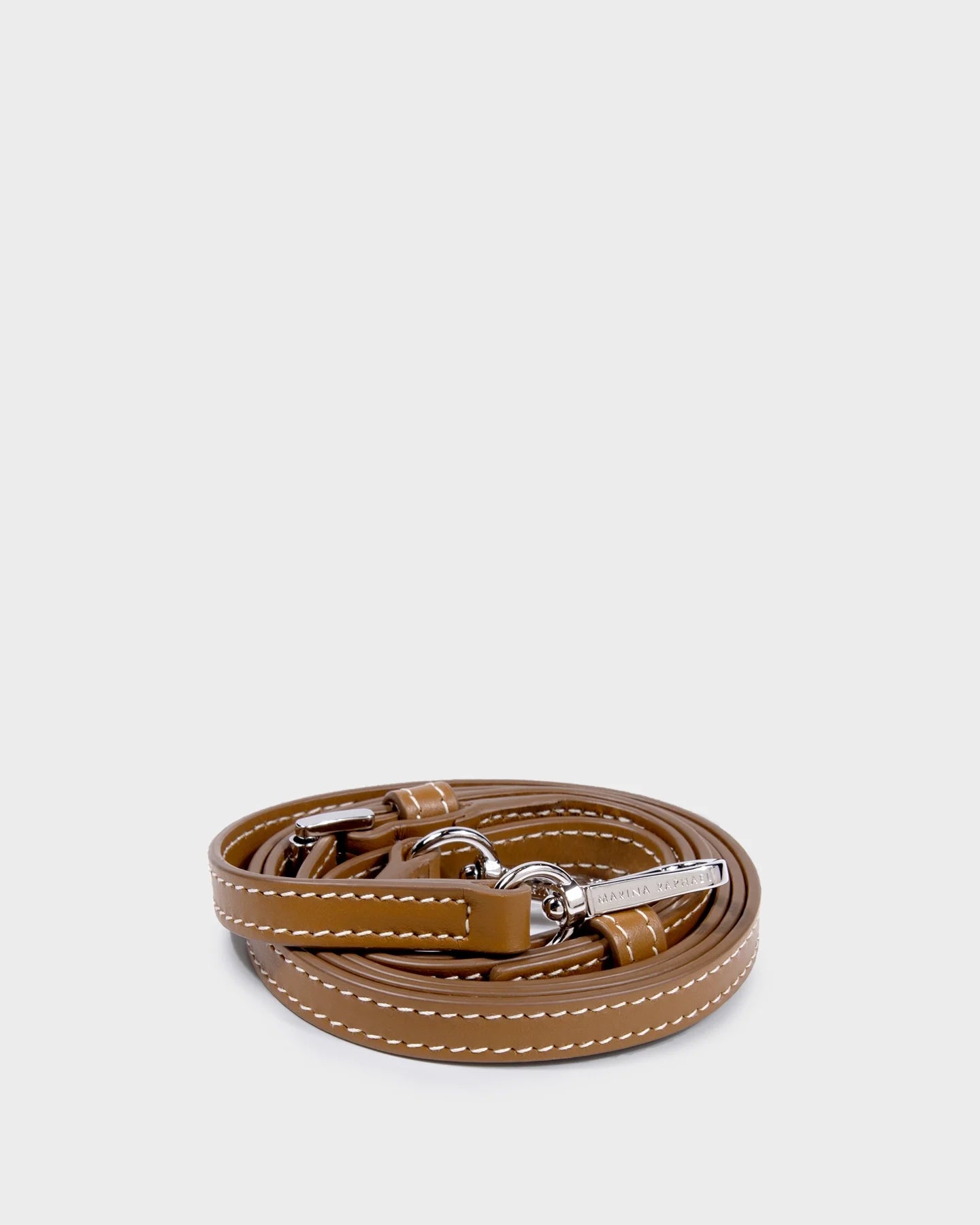 Thin, adjustable, caramel, napa leather strap with silver hardware and exposed stitching