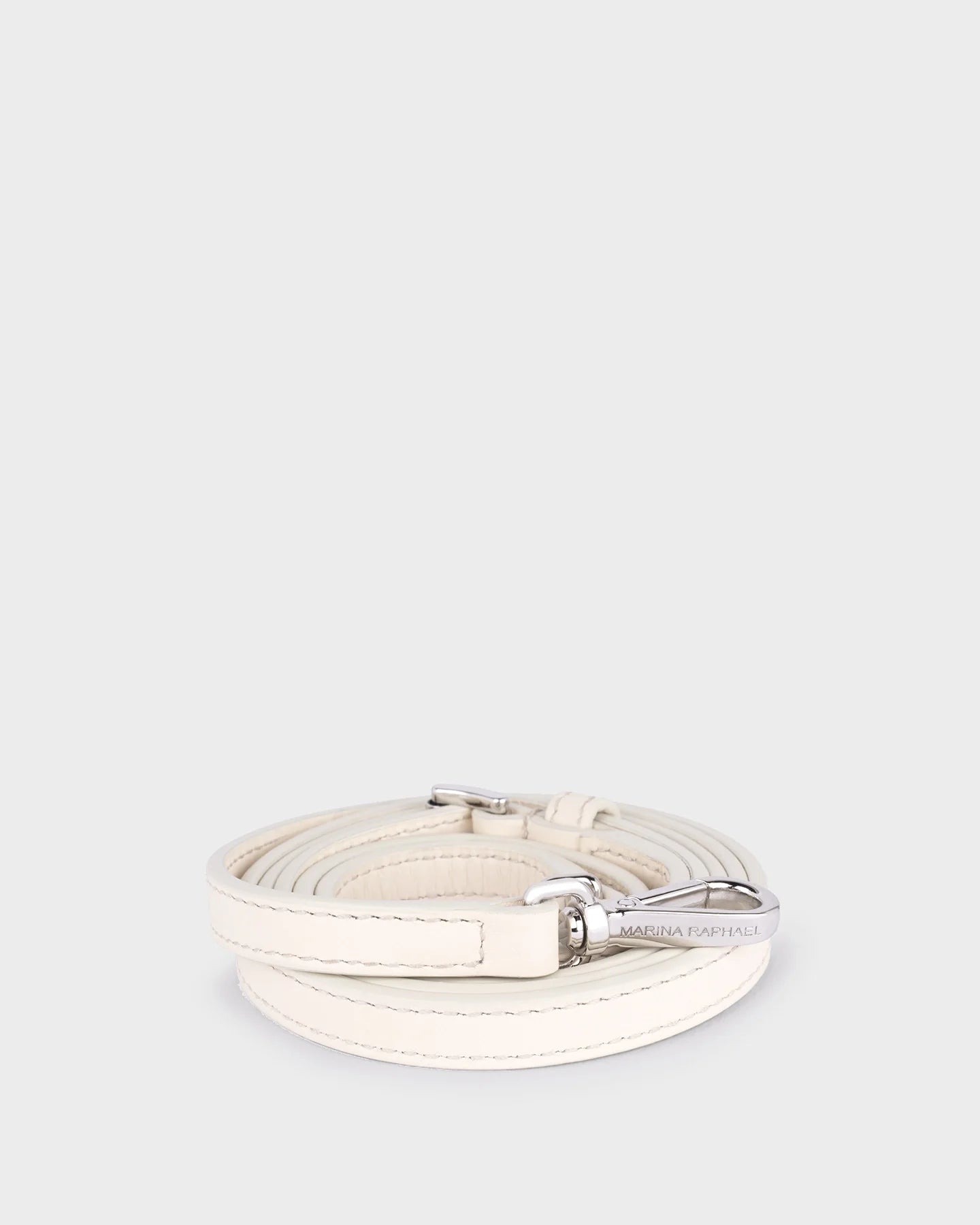 Thin, adjustable, cream leather strap with silver hardware