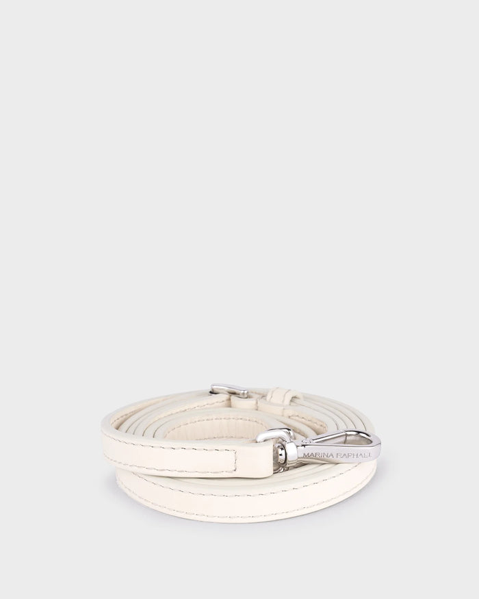 Thin, adjustable, cream leather strap with silver hardware