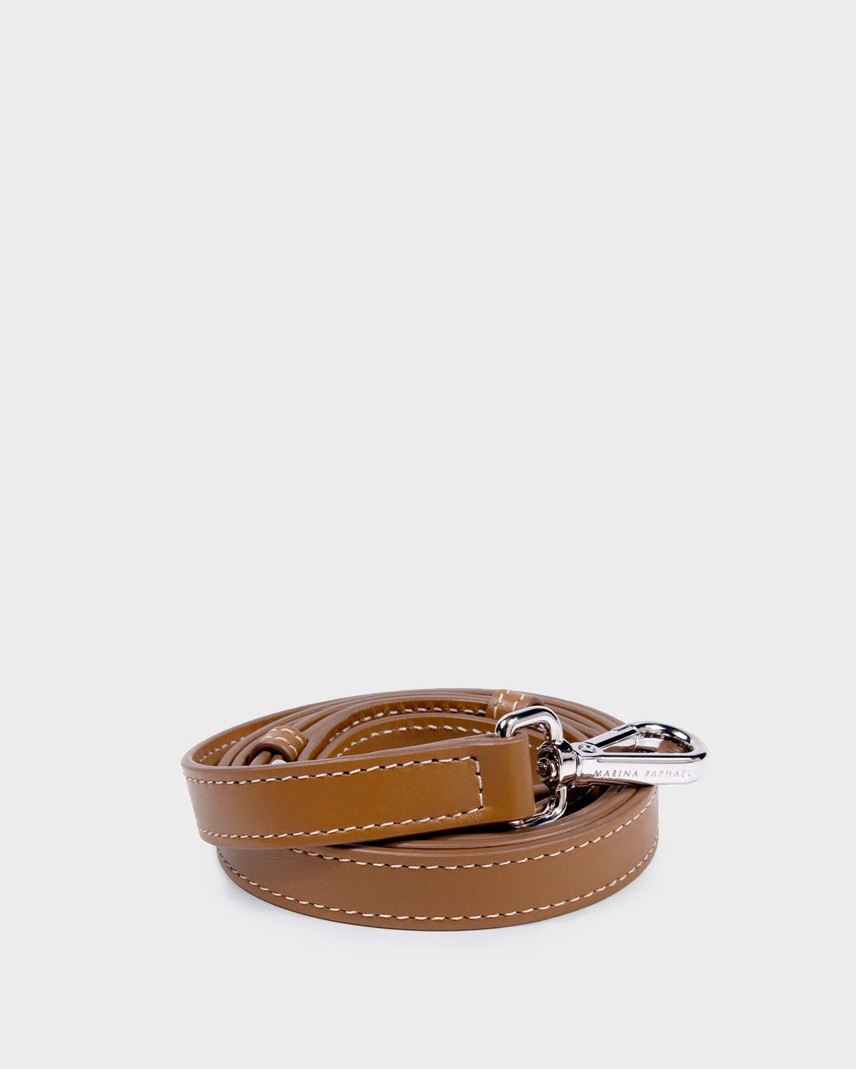 Thick, adjustable, caramel, napa leather strap with gold hardware and exposed stitching